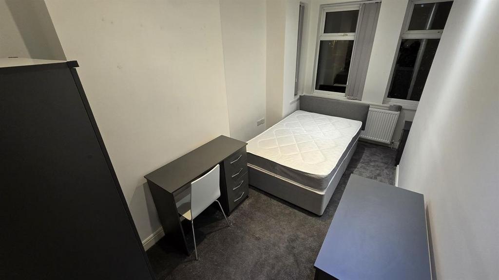 A neatly maintained bedroom featuring a large d...