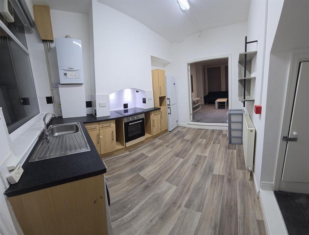 A spacious and modern kitchen area with ample c...