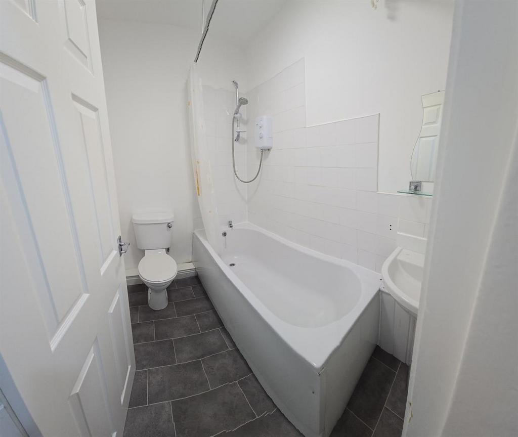 A clean and modern bathroom featuring a large b...