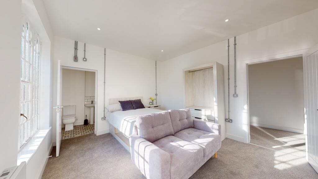 Bright and spacious master bedroom featuring a ...