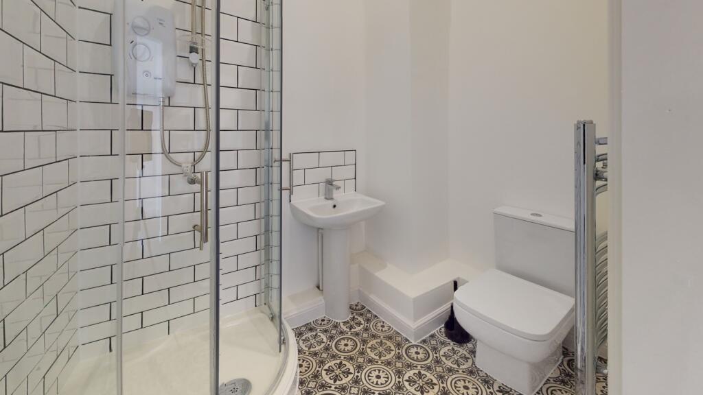 A bright and well-maintained bathroom featuring...