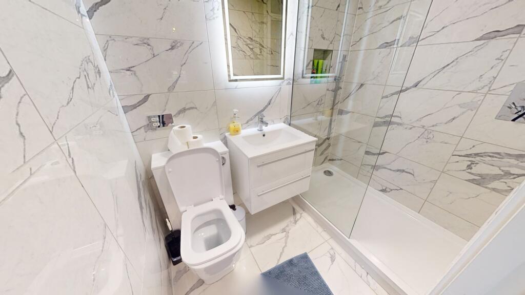 A modern, well-maintained bathroom with a large...