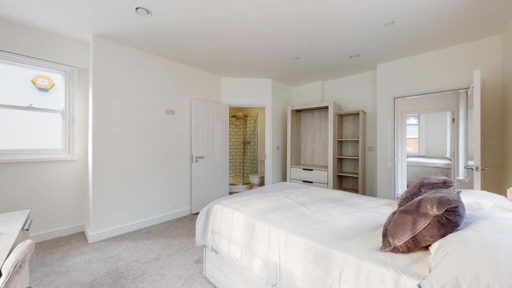 A spacious and well-maintained master bedroom w...