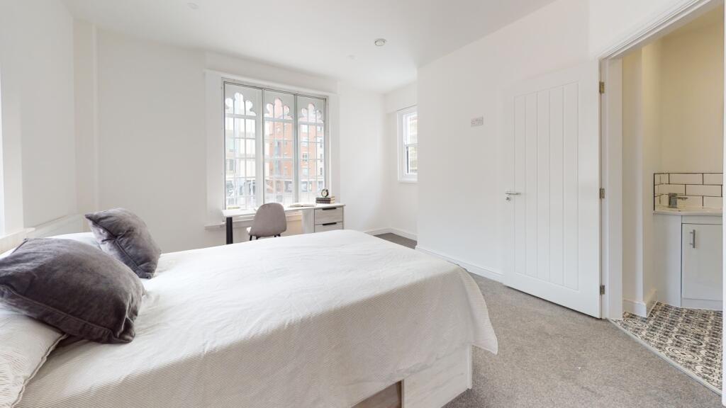 Bright and welcoming bedroom with large windows...