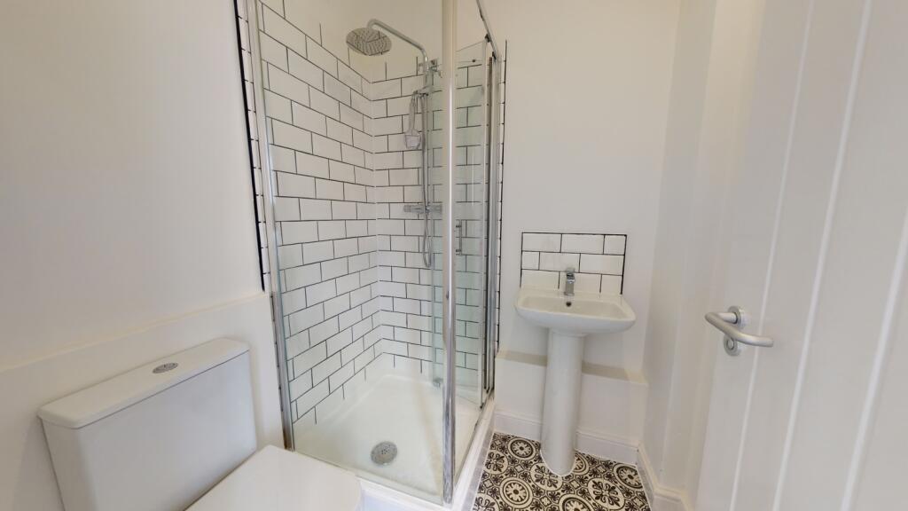 A clean and modern bathroom featuring a spaciou...