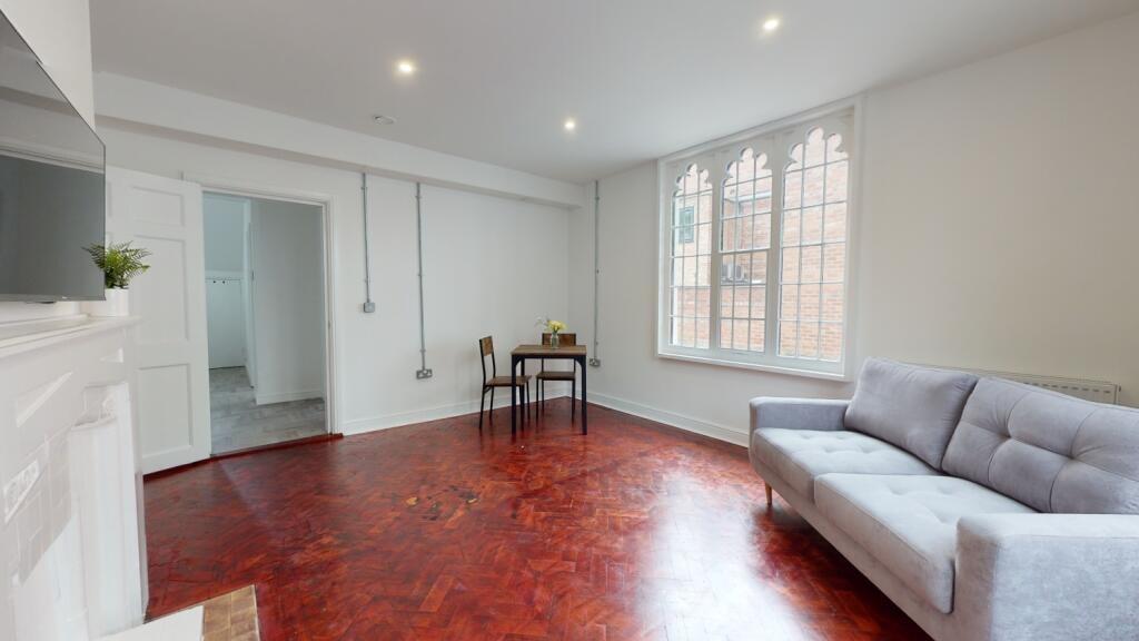 A spacious and bright living room featuring lar...