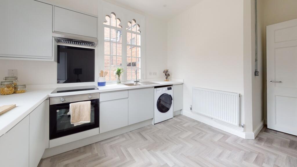 Bright and modern kitchen with ample natural li...
