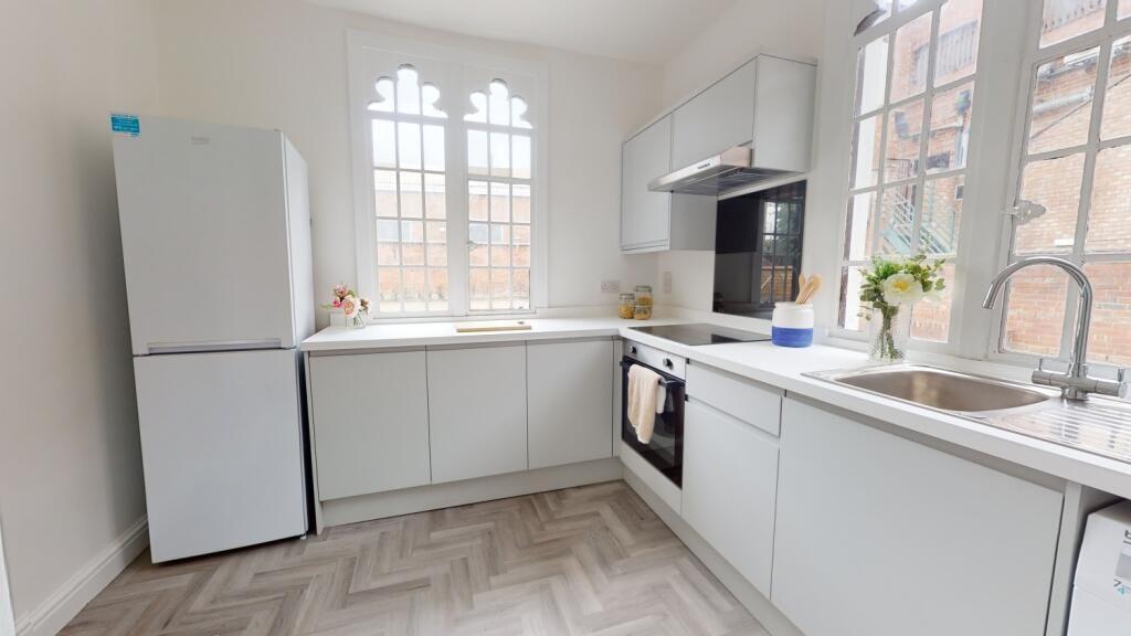 Bright and modern kitchen with ample natural li...