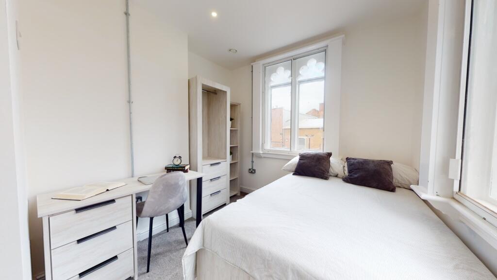 Bright and spacious double bedroom featuring a ...