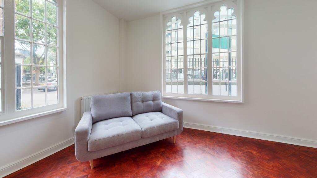 Bright and inviting living room featuring large...