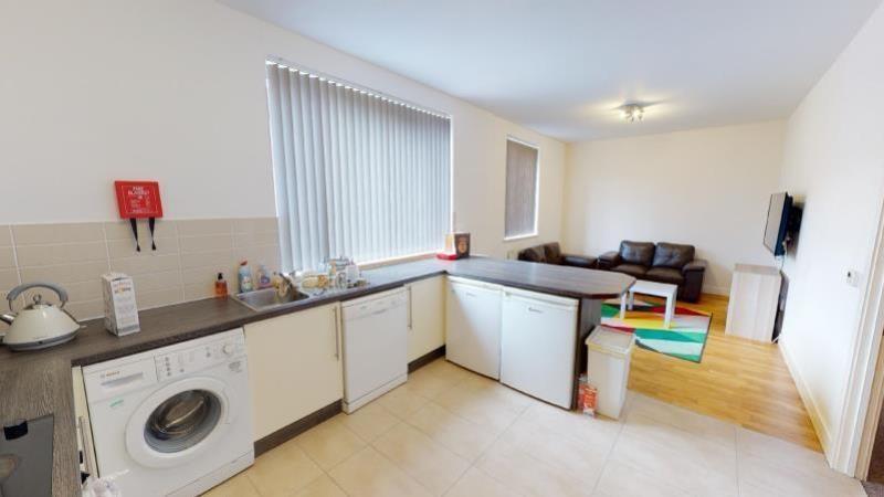 A spacious and well-lit living room with large ...