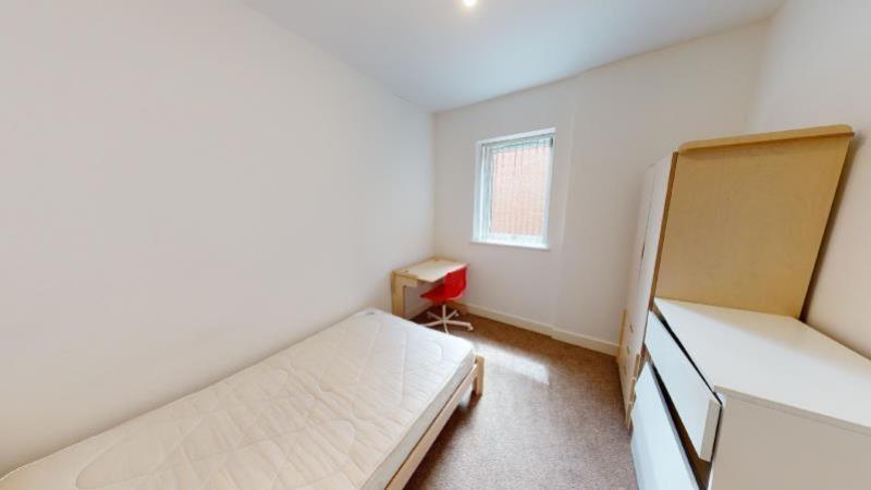 A bright and tidy bedroom with a single bed, a ...