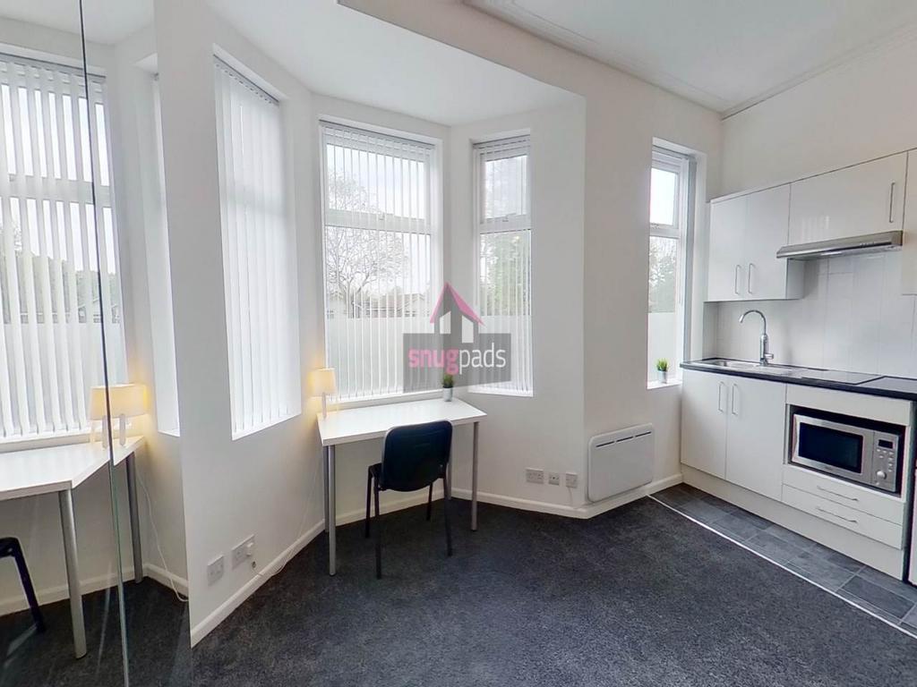 Bright and modern kitchen area featuring natura...