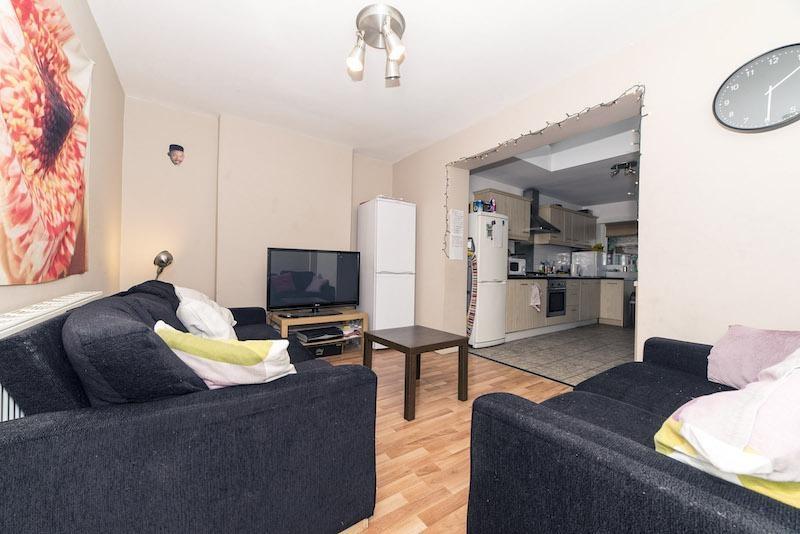 Bright, modern living area with comfortable dar...