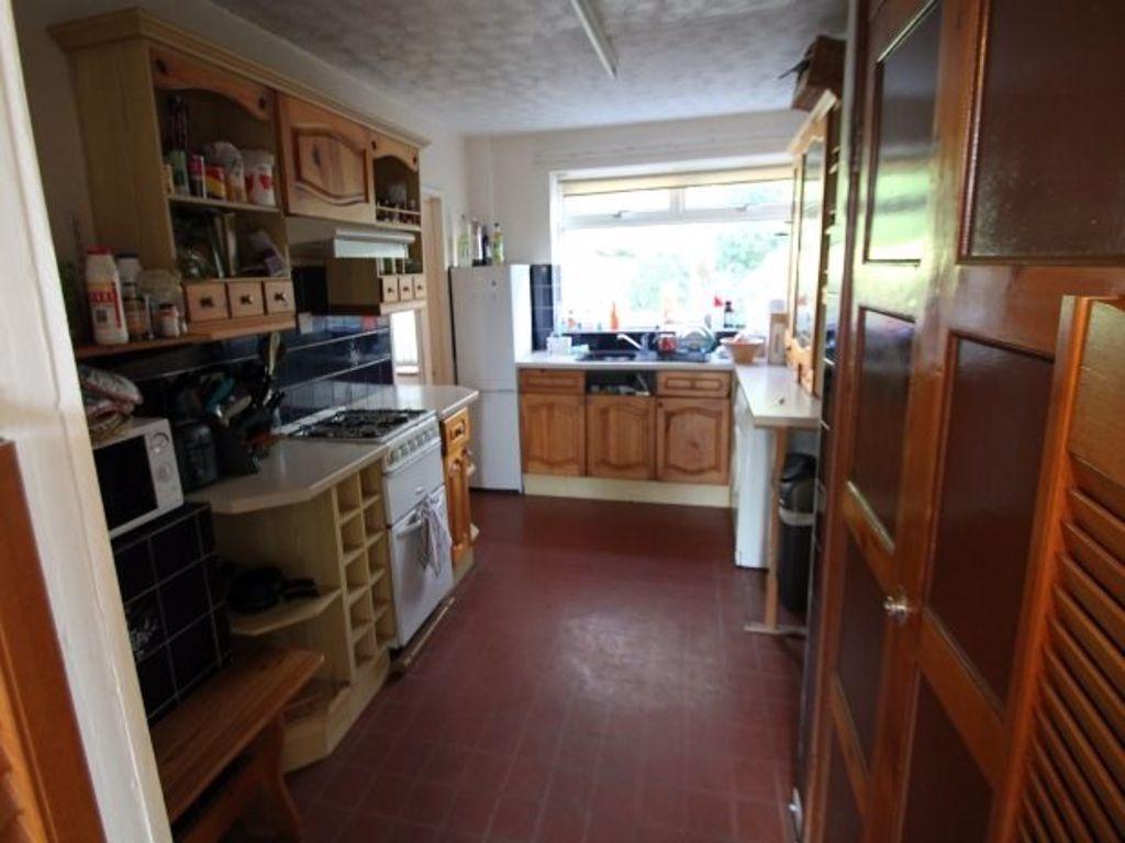 A modest kitchen with natural light coming thro...