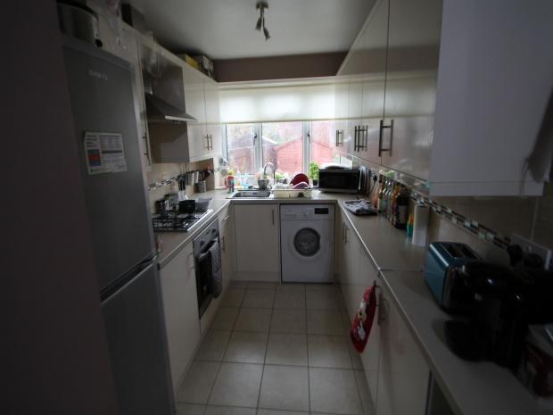 A bright and well-maintained kitchen with ample...