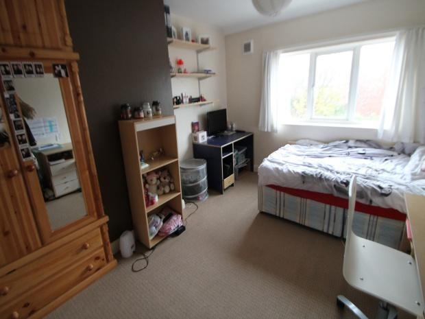 A cozy bedroom featuring a double bed, a wardro...