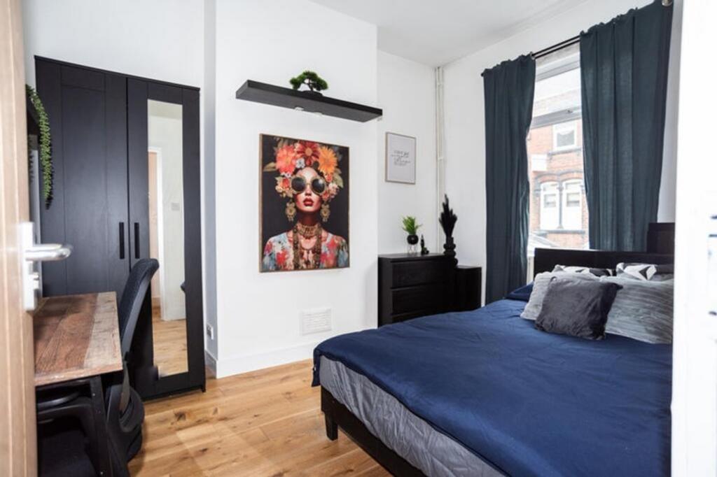 This inviting double bedroom features a comfort...