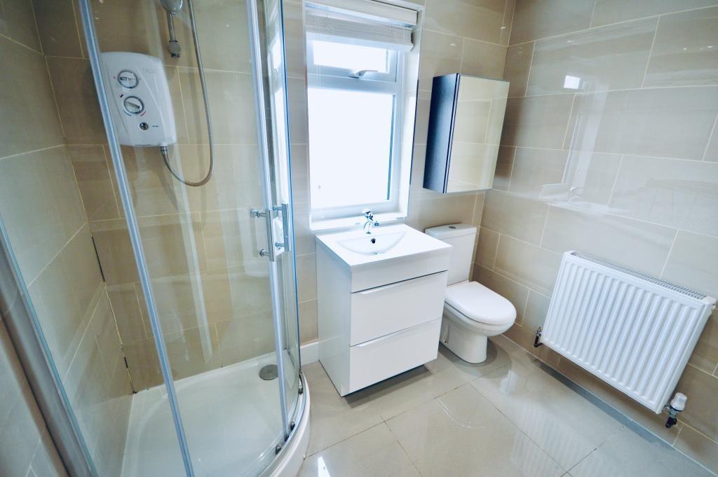 A clean and modern bathroom featuring a shower ...