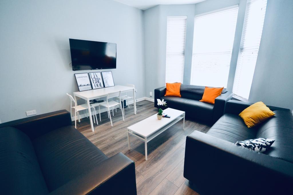 A bright and modern living room with large wind...