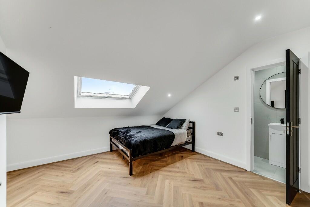 A bright, clean bedroom with a large window pro...