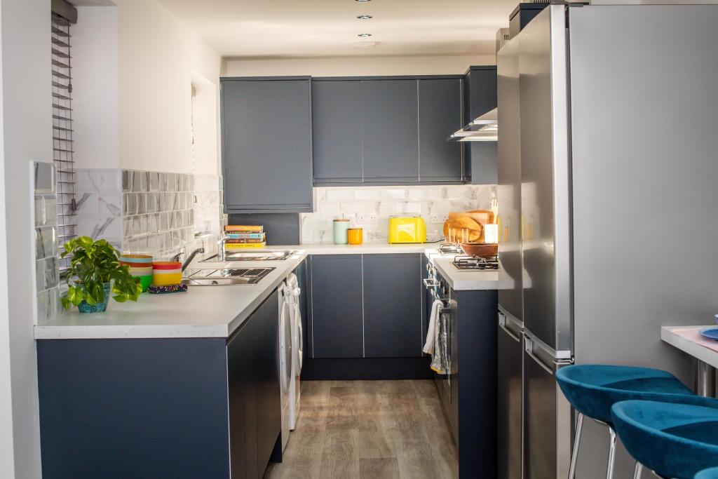 A modern and well-maintained kitchen with sleek...