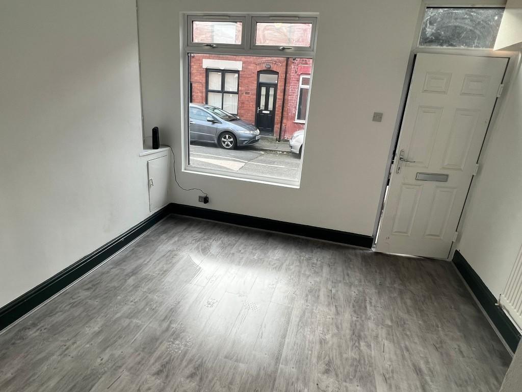 A bright and clean room with a large window all...