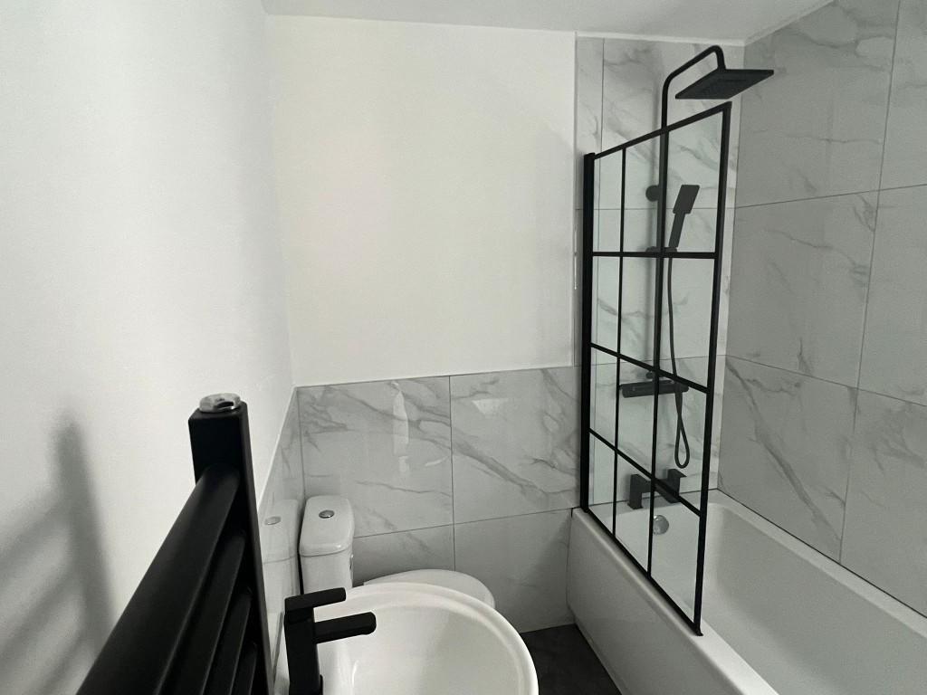Modern bathroom featuring a large shower enclos...