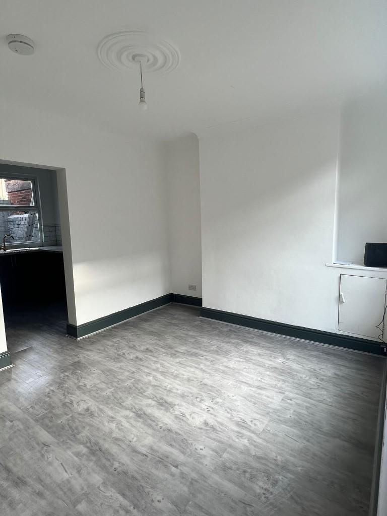 A bright and spacious living room with large wi...