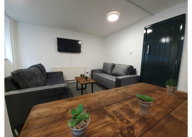 A modern, well-lit living room featuring contem...
