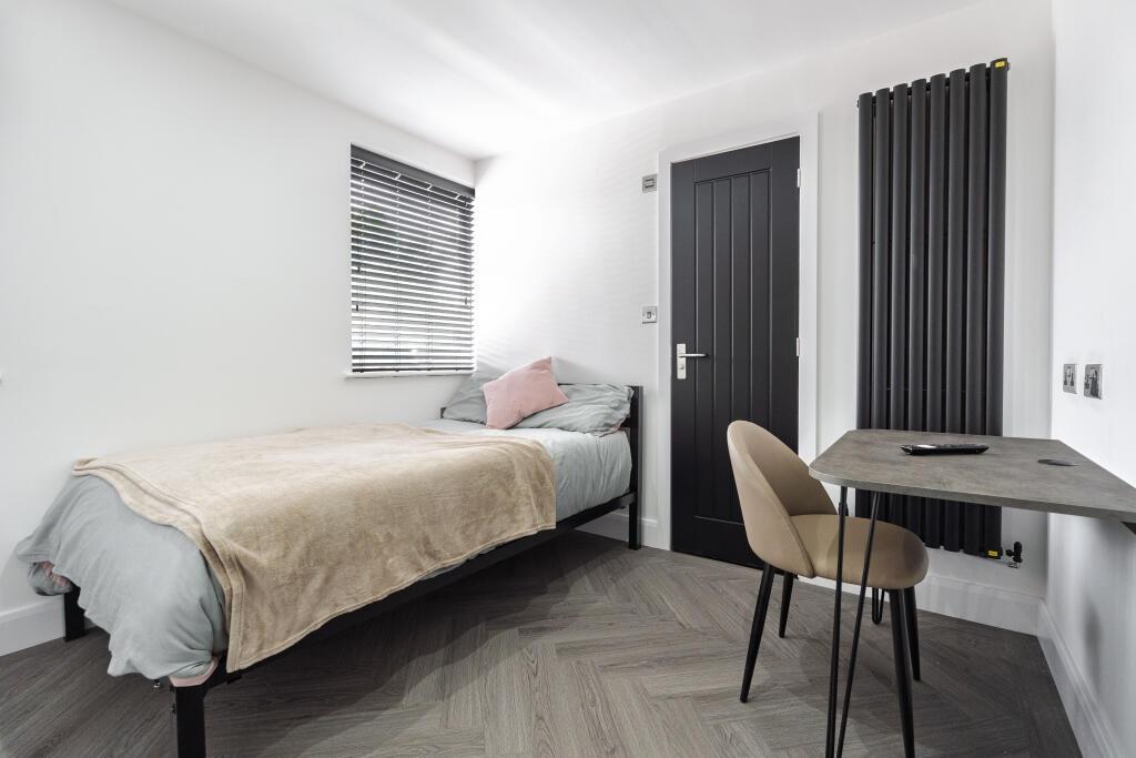 A contemporary bedroom featuring a comfortable ...