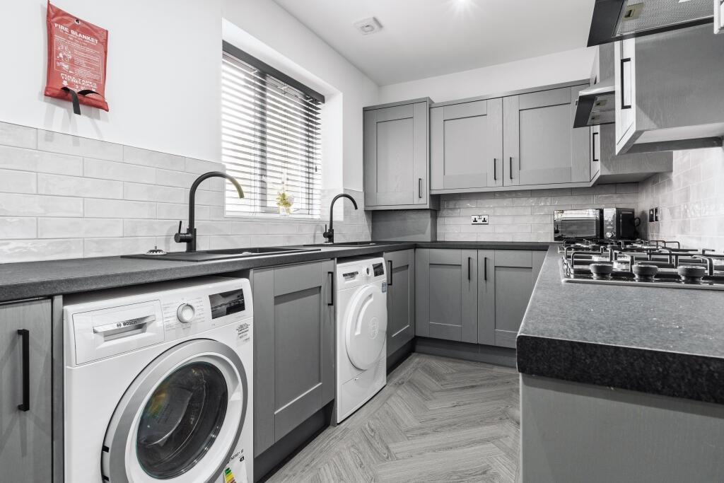 A modern, well-maintained kitchen featuring gre...