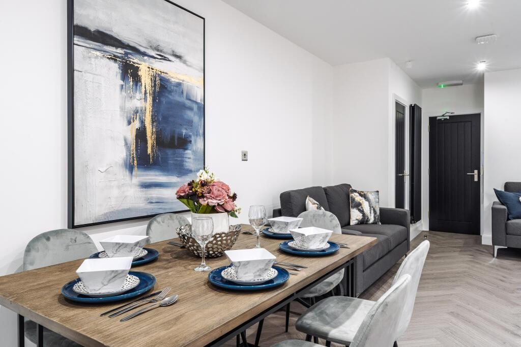 A modern, well-lit living room featuring comfor...