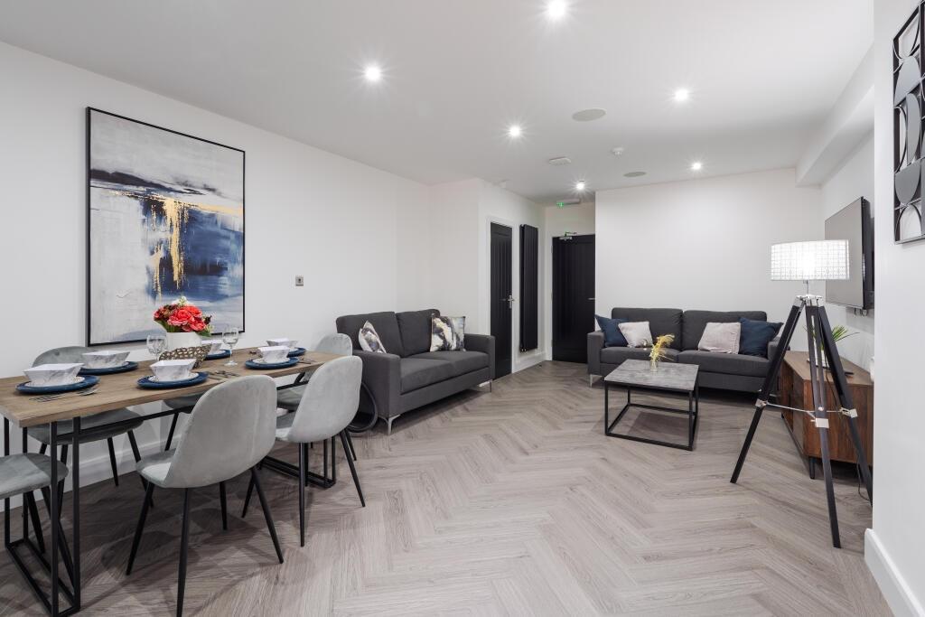 Modern and spacious living area featuring comfo...