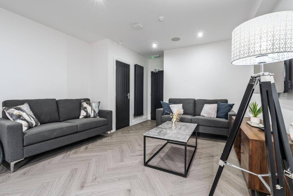A modern, spacious living room featuring neutra...