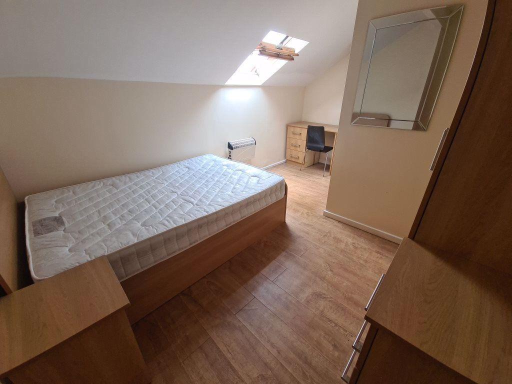 A cozy single bedroom featuring a comfortable b...