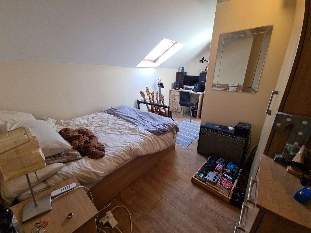 A cozy bedroom featuring a comfortable bed with...