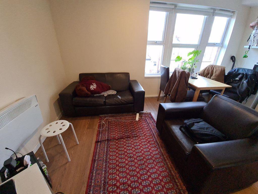 A bright and inviting living room featuring a c...