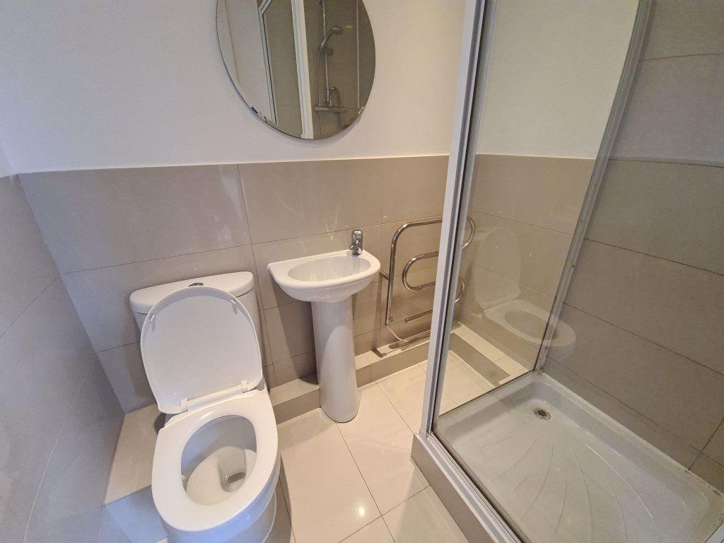 A clean, modern bathroom featuring a toilet, a ...