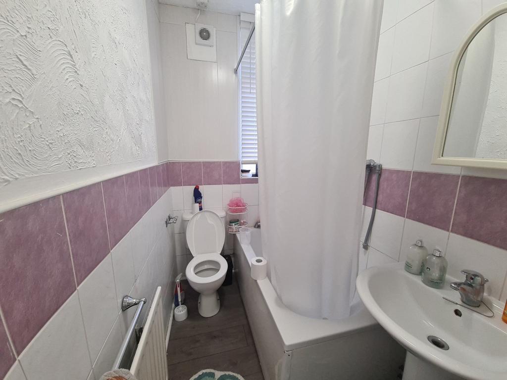 A functional and tidy bathroom with a shower, t...