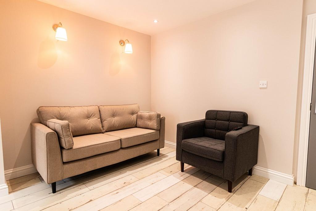 A cozy and well-maintained living room featurin...