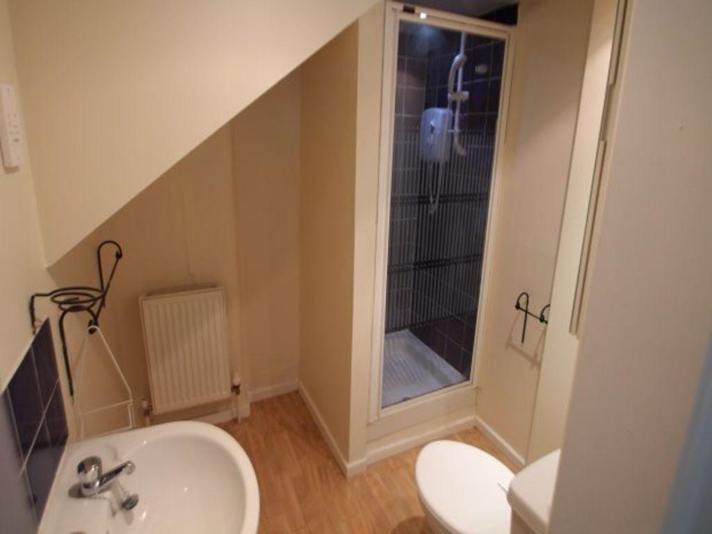 A clean and functional bathroom featuring a sho...