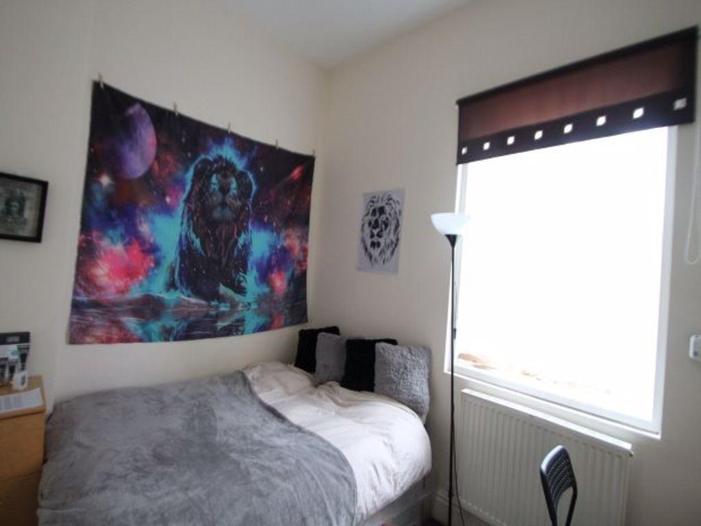 Cozy single bedroom featuring a comfortable bed...
