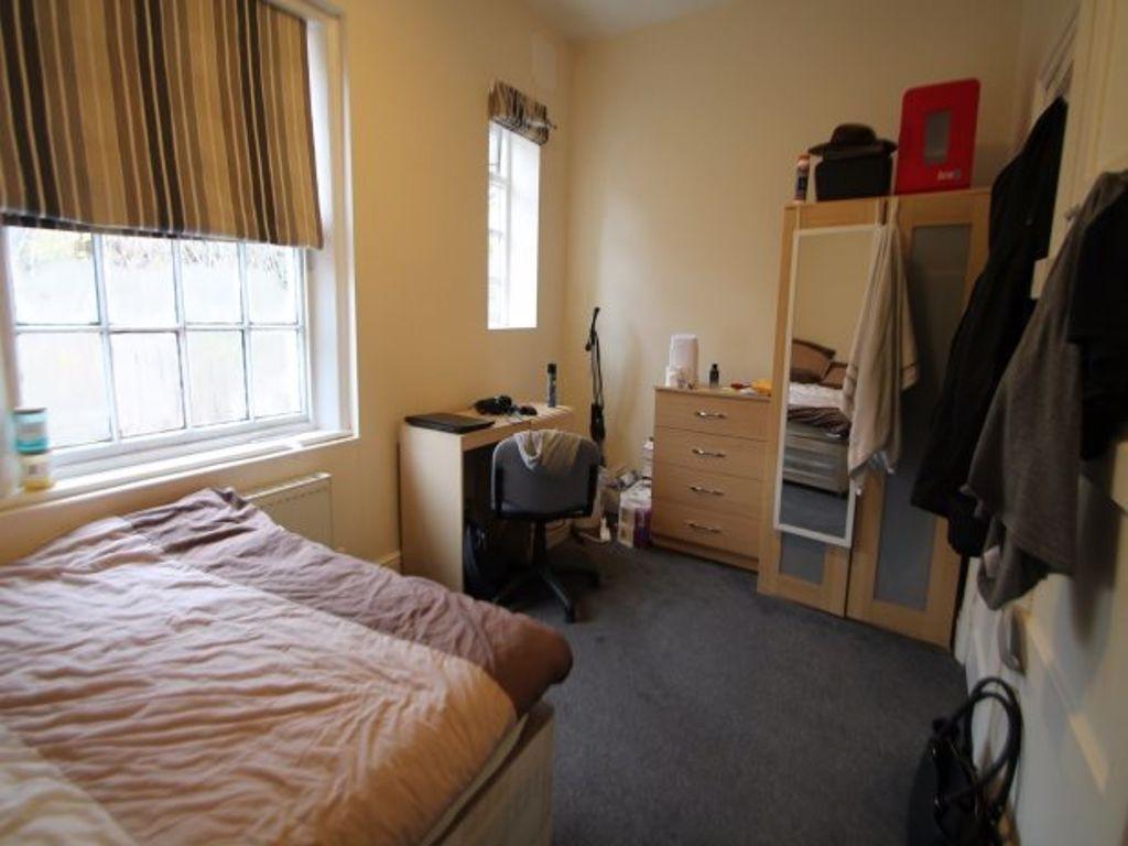 Cozy single bedroom featuring a comfortable bed...