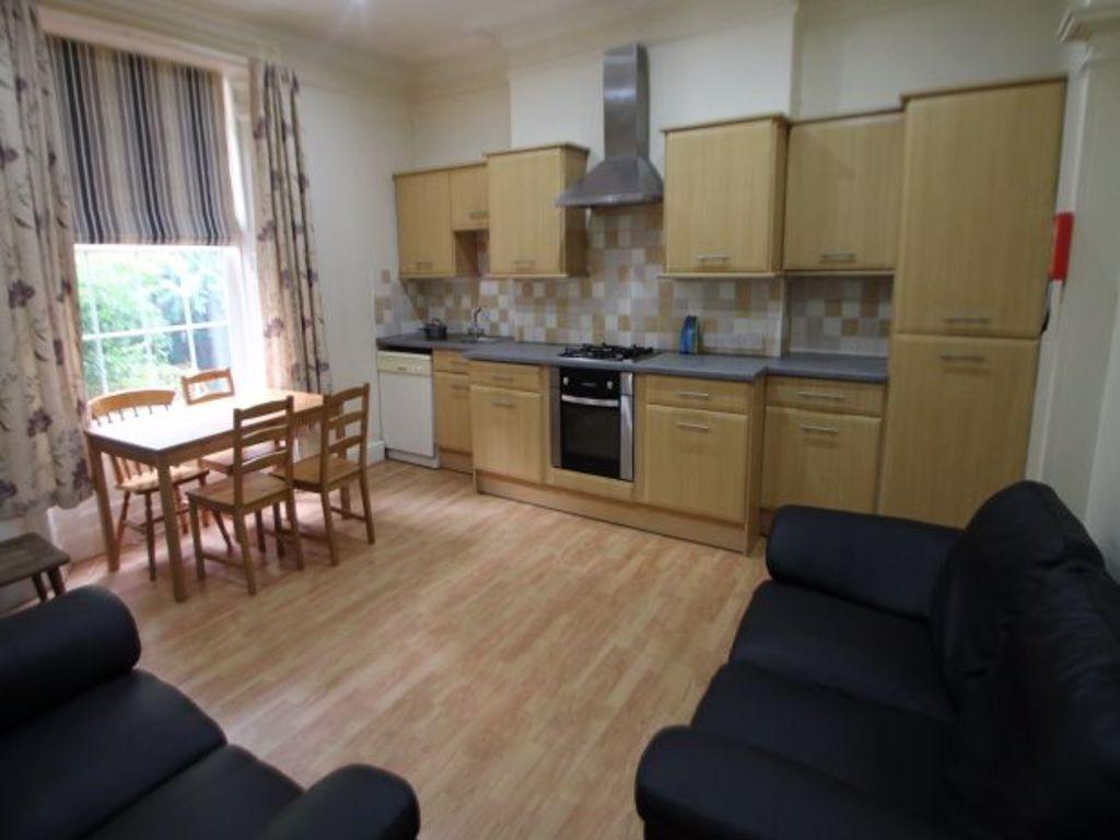 A bright and tidy kitchen featuring wooden cabi...