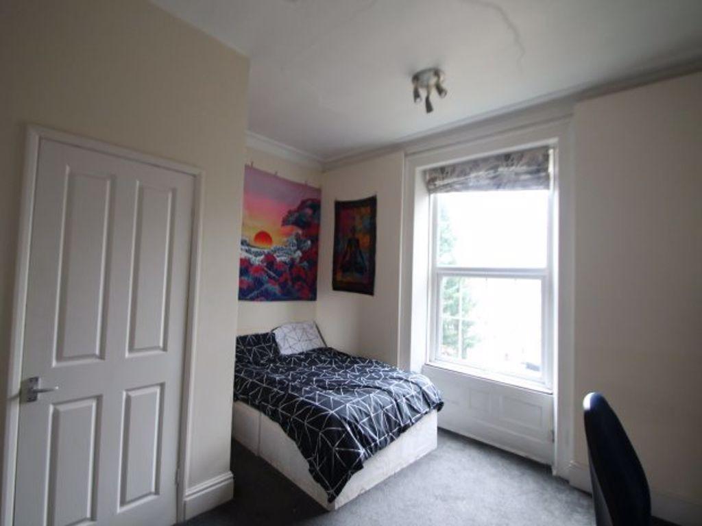 A cozy double bedroom featuring a large window ...