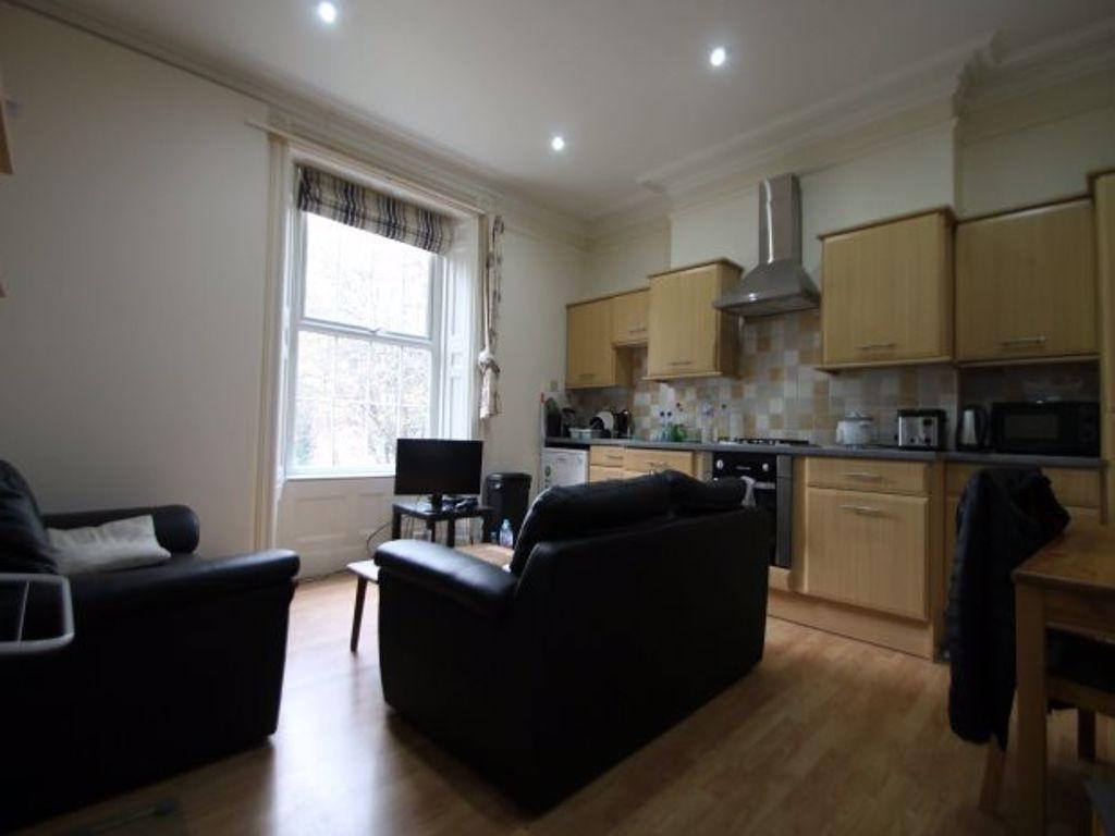 A bright and tidy kitchen-living area featuring...