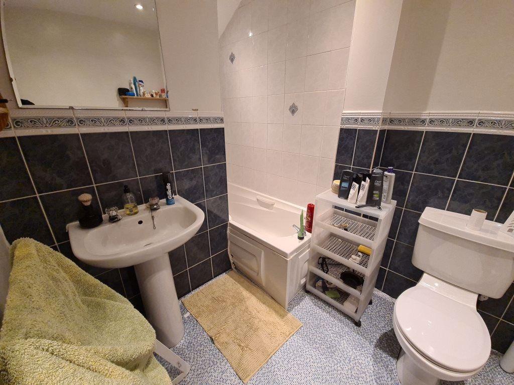 A well-maintained bathroom suite featuring a la...