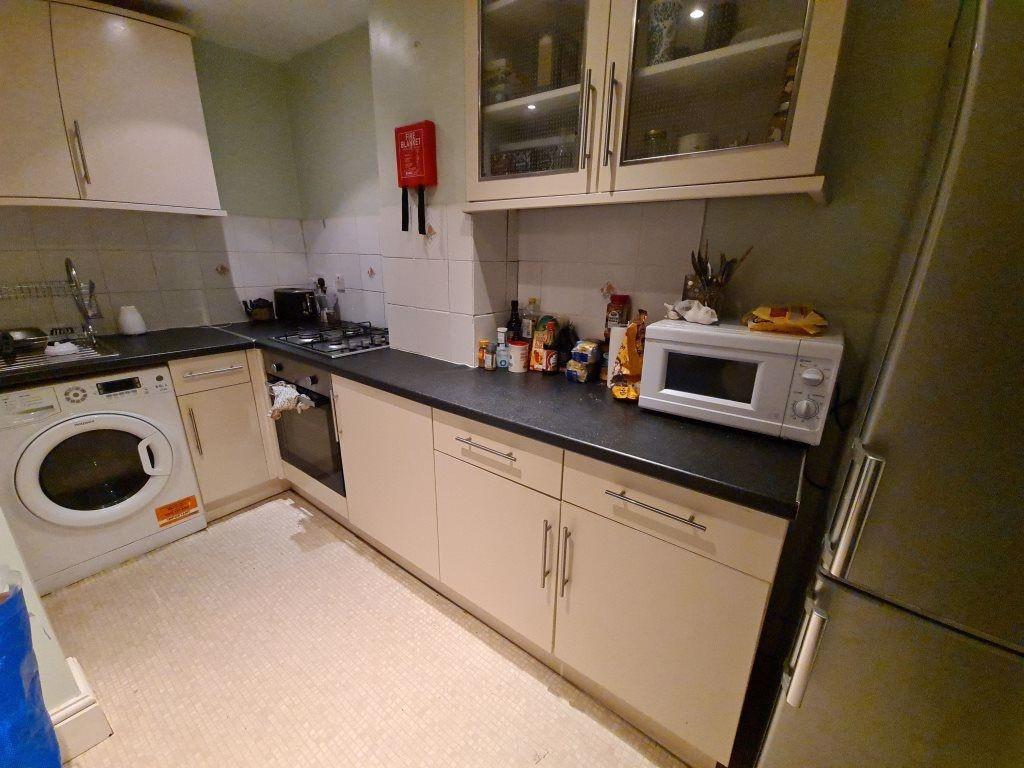 A functional and tidy kitchen area featuring a ...