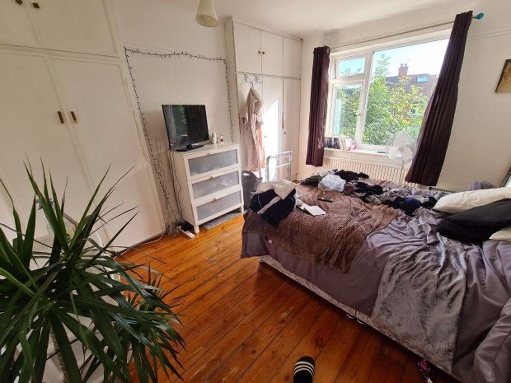 A cozy bedroom with a double bed positioned nea...